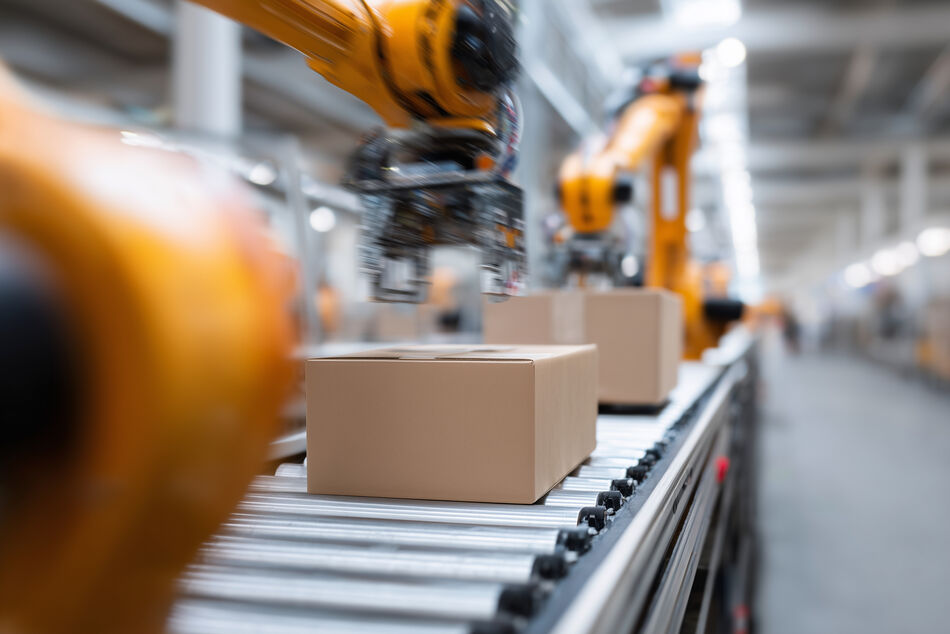 Automated Robot Material Handling in Packaging Line Industrial robots performing automated box handling on conveyor system in material handling application